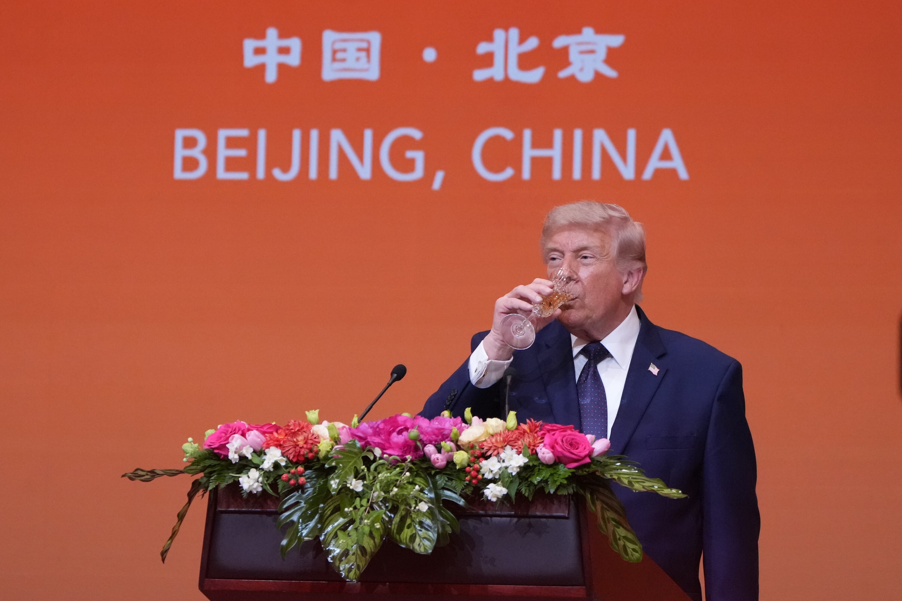 President Donald Trump drinks during a state dinner with China's President Xi Jinping at the Great Hall of the People on Thursday May 14, 2026, in Beijing. (AP Photo/Mark Schiefelbein)